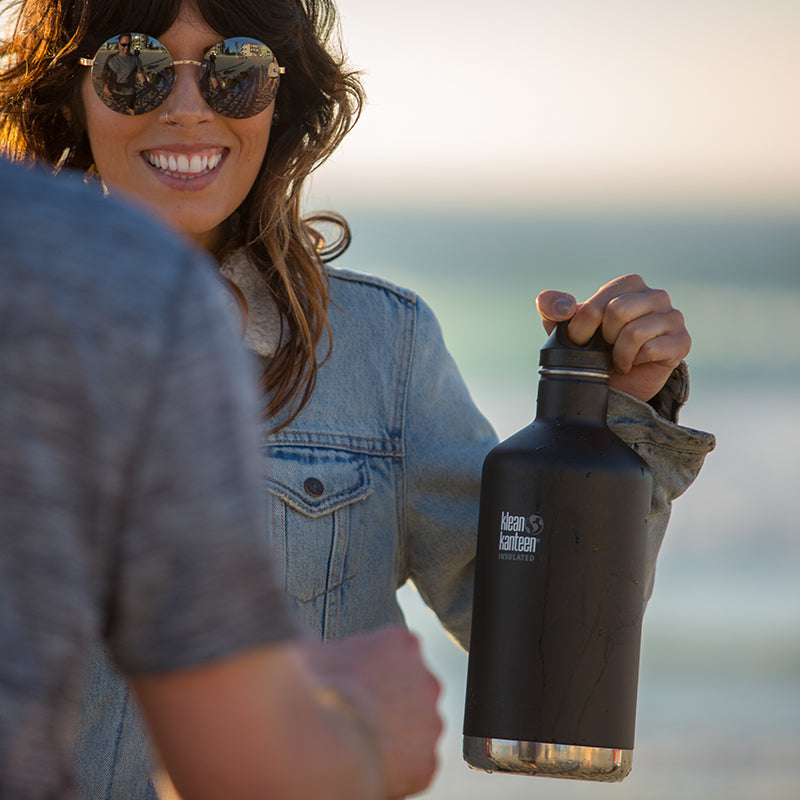 64oz-classic-with-loop-cap-g5 64oz_insulated_classic_black_beach_girl_hand_square.jpg