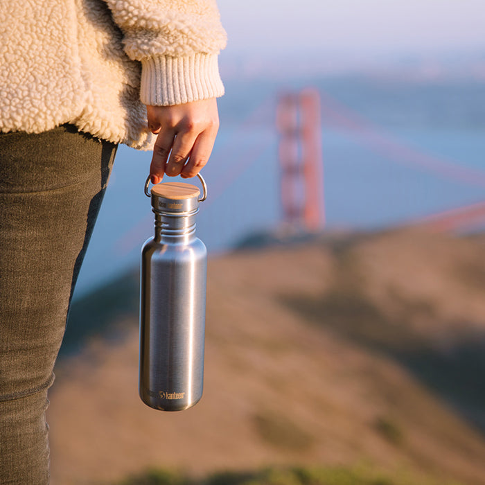27oz-reflect-with-bamboo-cap-t7 K27SSLRF-BS-BAMBOO_reflect_bottle_bridge_lifestyle.jpg